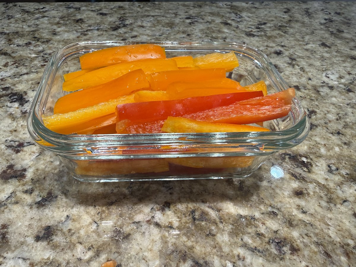 Glass container of bell pepper sticks, cut and ready to grab